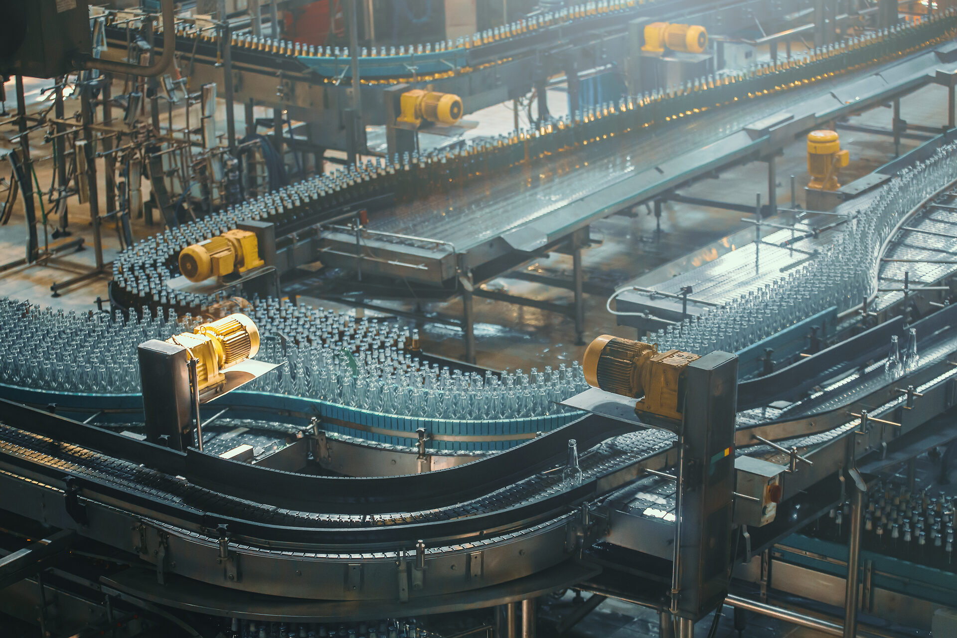 Conveyor belt with bottles on an industrial brewery production line